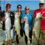 Two Couples showing their Lake Trout